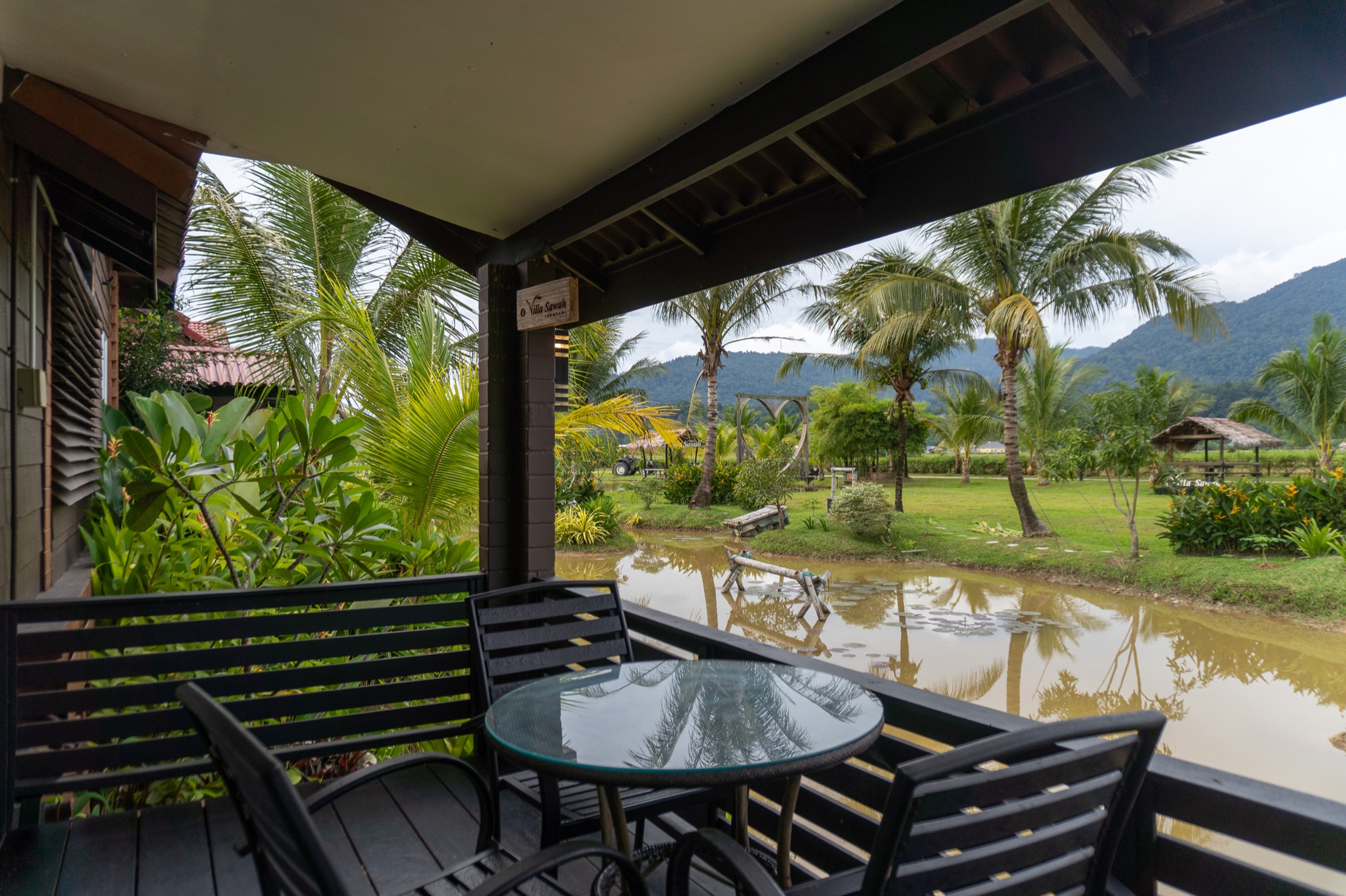 Covered breakfast terrace overlooking pond and mountains
