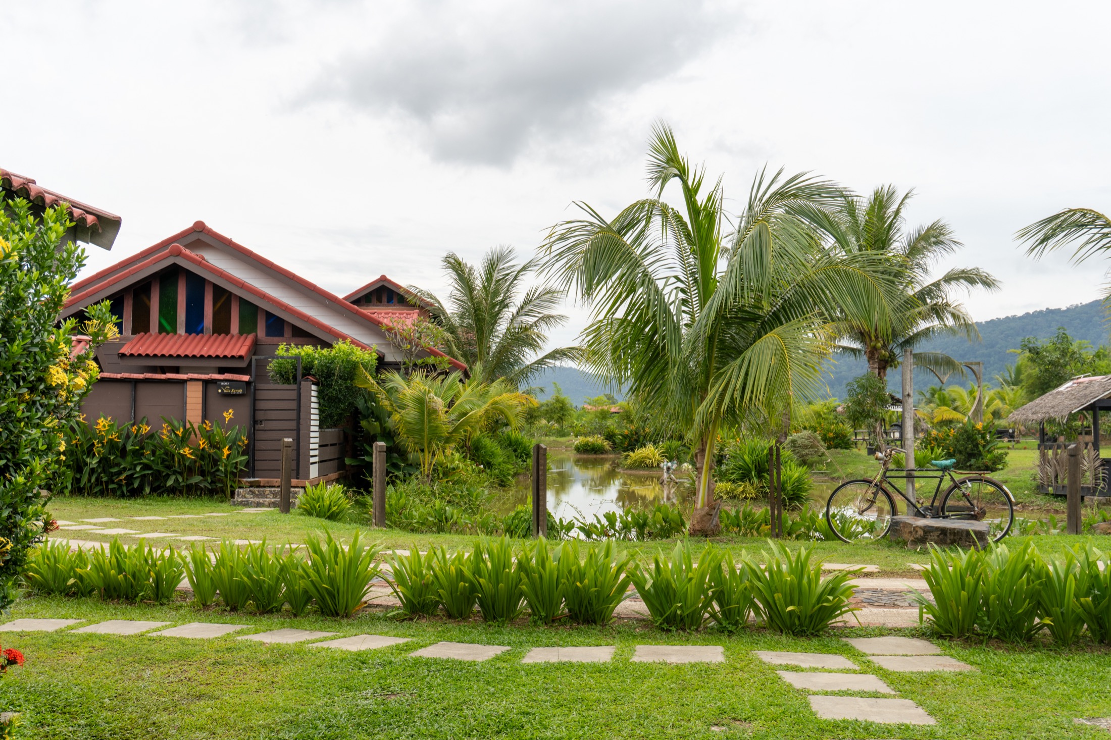 Villa Sawah compound with palms, garden and village setting