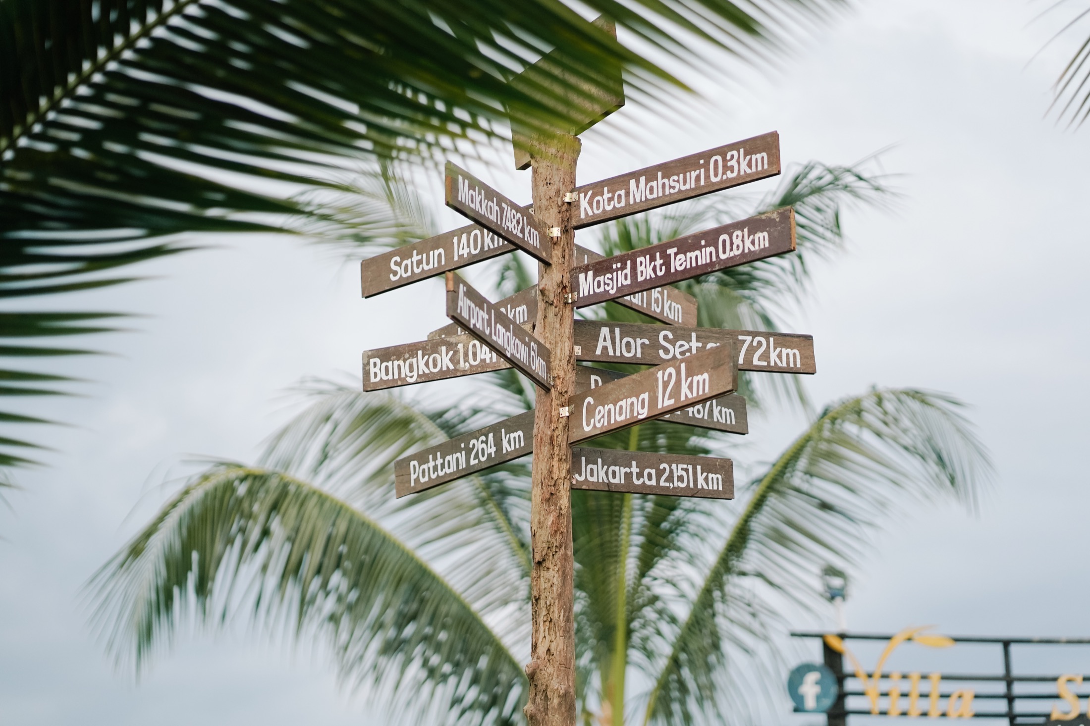 Wooden signpost showing local Langkawi distances